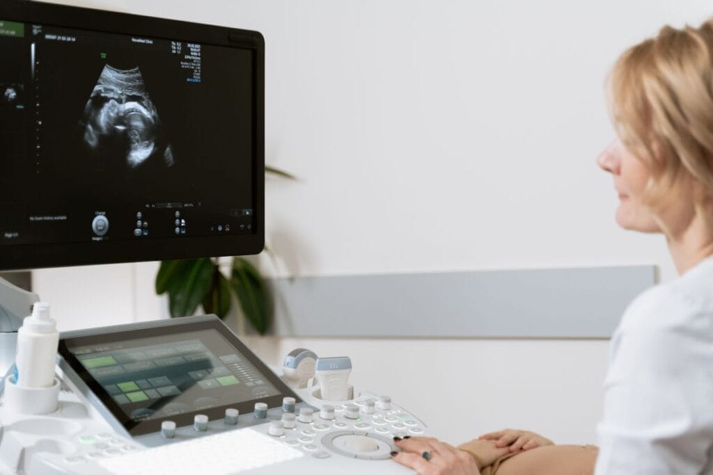 Pregnant woman undergoing an anomaly scan ultrasound performed by a clinician in Amravati