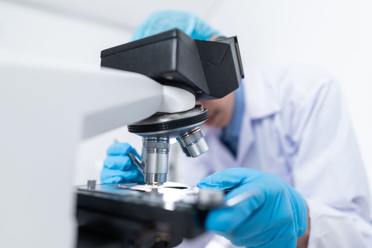 Embryologist using a microscope in the IVF lab at Shubham Hospitals, Amravati