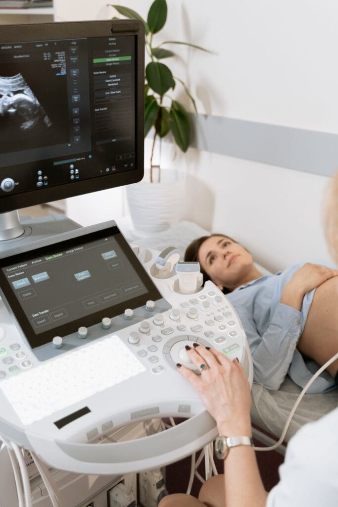 Obstetrician performing an antenatal check-up for a pregnant woman in Amravati during monsoon season